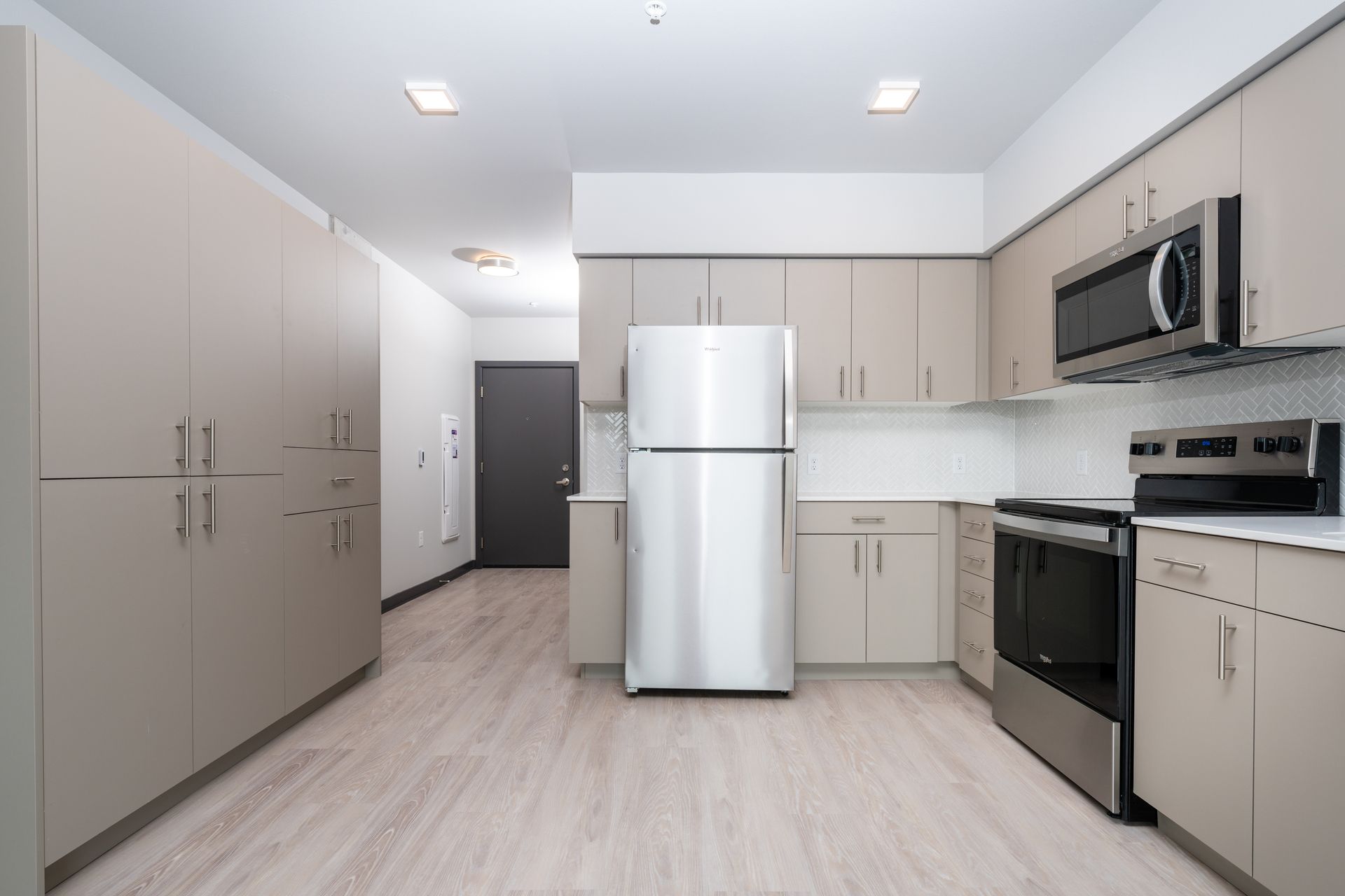 kitchen with brown cabinets and stainless steel fridge