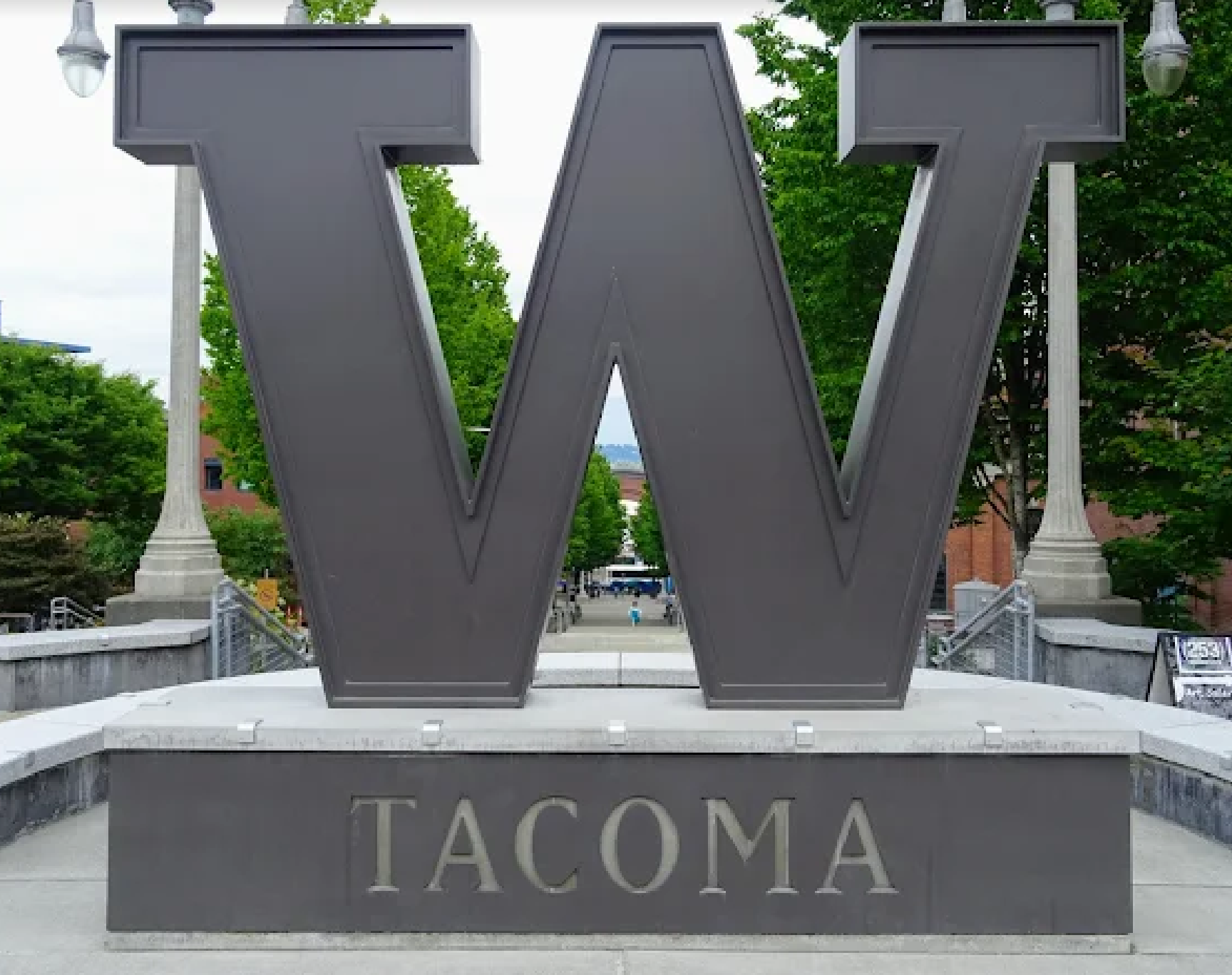 A large white building with a balcony and a lot of windows.
