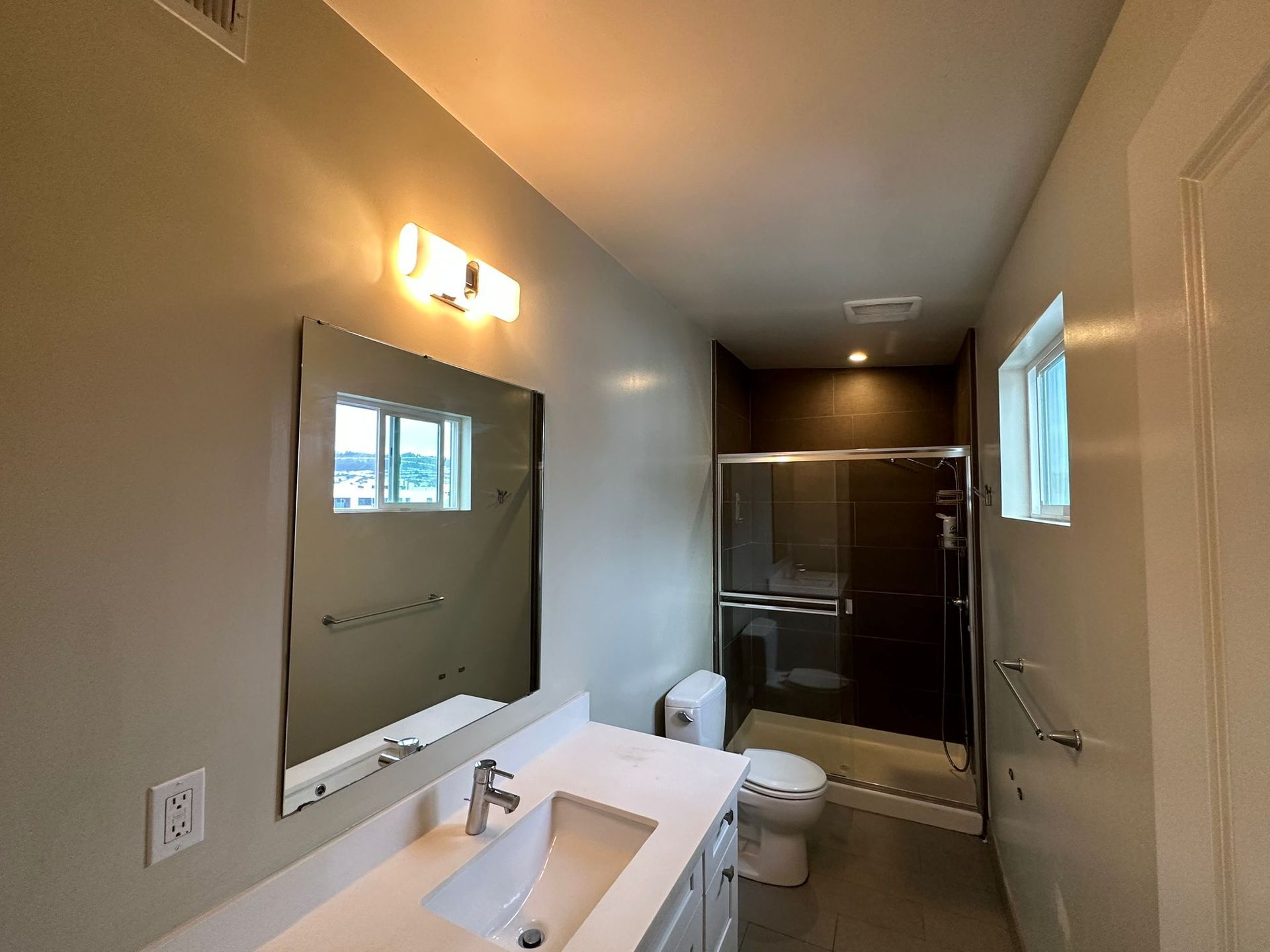 A bathroom with a toilet , sink , shower and bathtub.