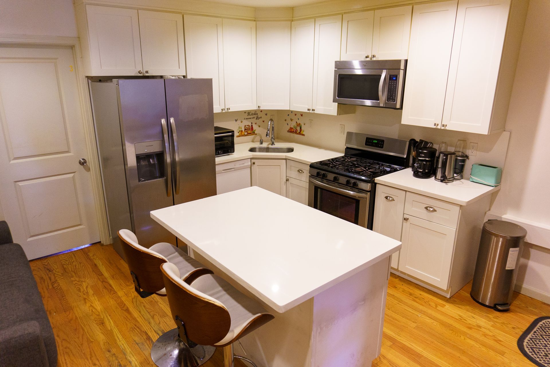 A room with bunk beds and a bathroom in the background