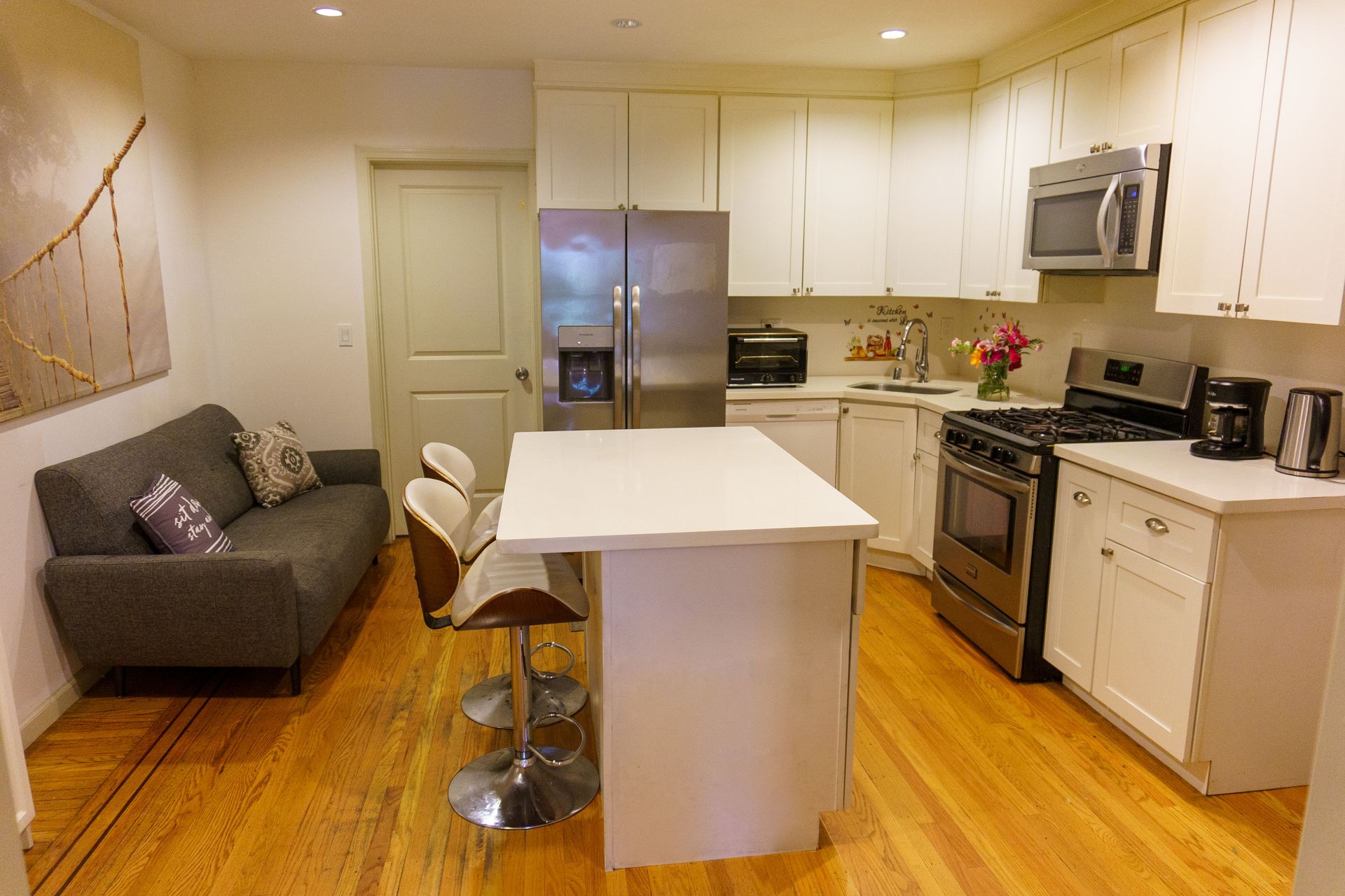 A kitchen with stainless steel appliances and white cabinets