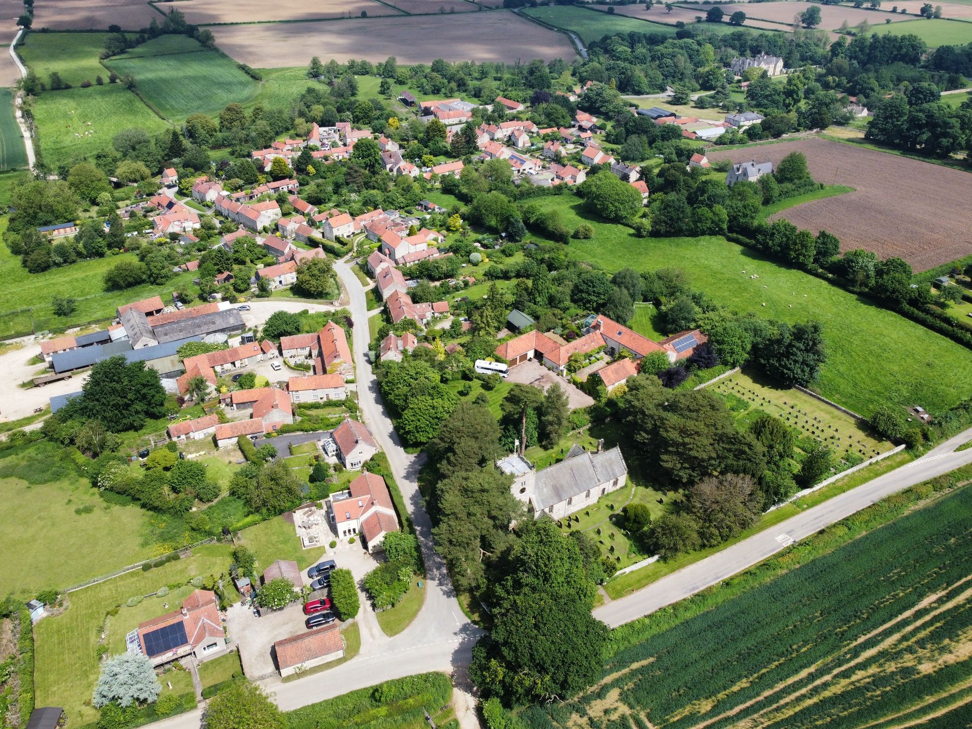 An aerial view of Nunnington Estate surrounded by fields and trees