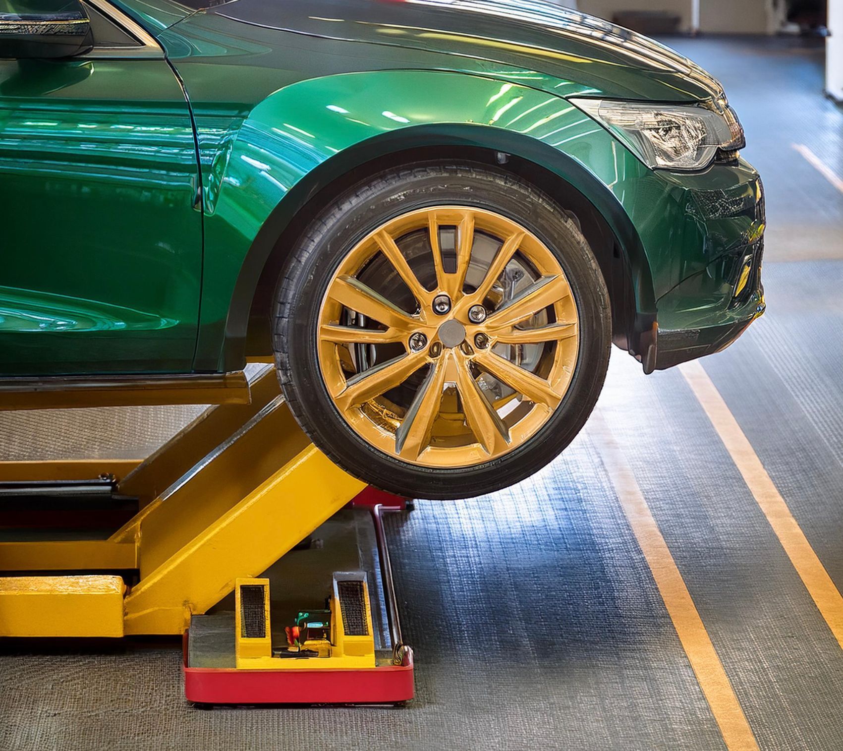 The image shows a vehicle racked on a hoist lifting it off the ground in preparation for an engine oil and filter change service