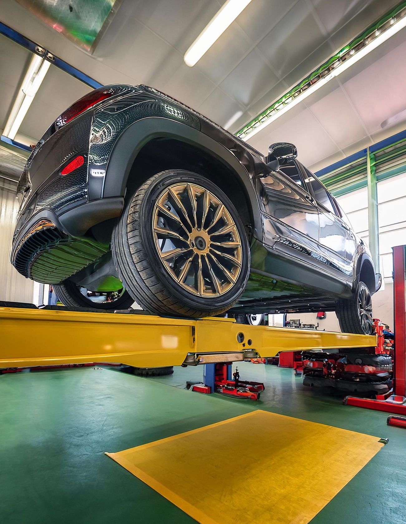 The image shows a hummer-like vehicle racked on our mechanics auto repair rack in preparation for auto repair and service in Redwood City, CA