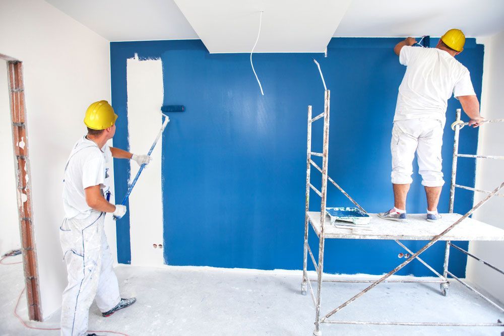 Professional Room Painter Adding the Final Touches to a New Home Wall — Painters in Scone, NSW