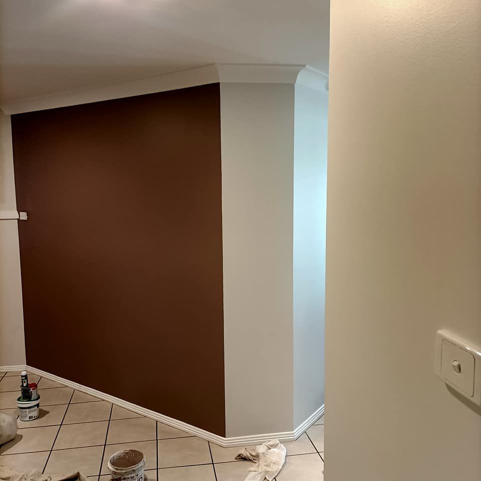 A Man Holds a Spray Gun and a Palette of Colours — Painters in Cessnock, NSW