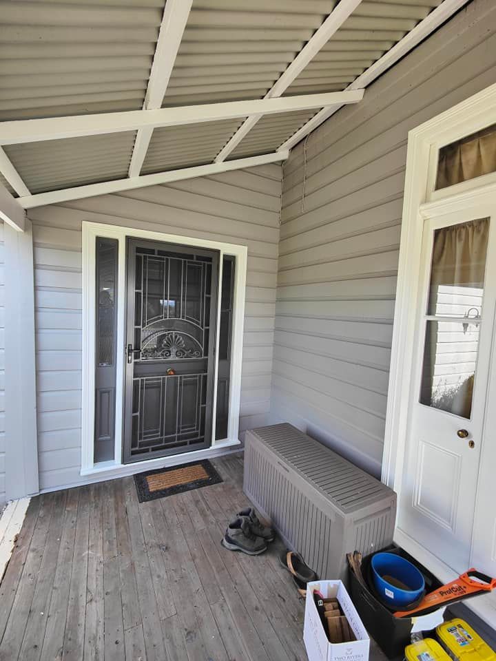 Men Painting Building Facade at Height Using Lifting Cradle and Hardhats — Commercial Painting in the Hunter Valley, NSW