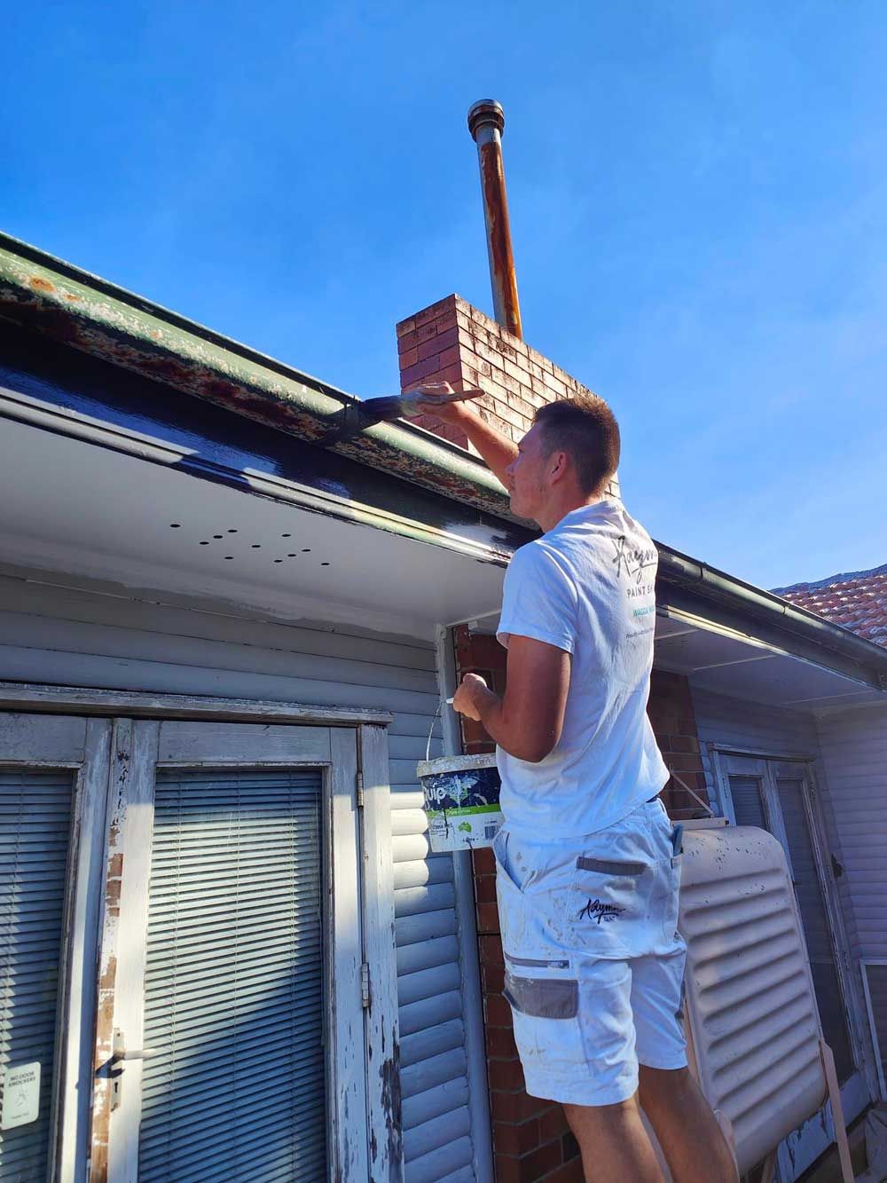 Man Painting the Sides of the Roof — Exterior Painter in the Hunter Valley, NSW