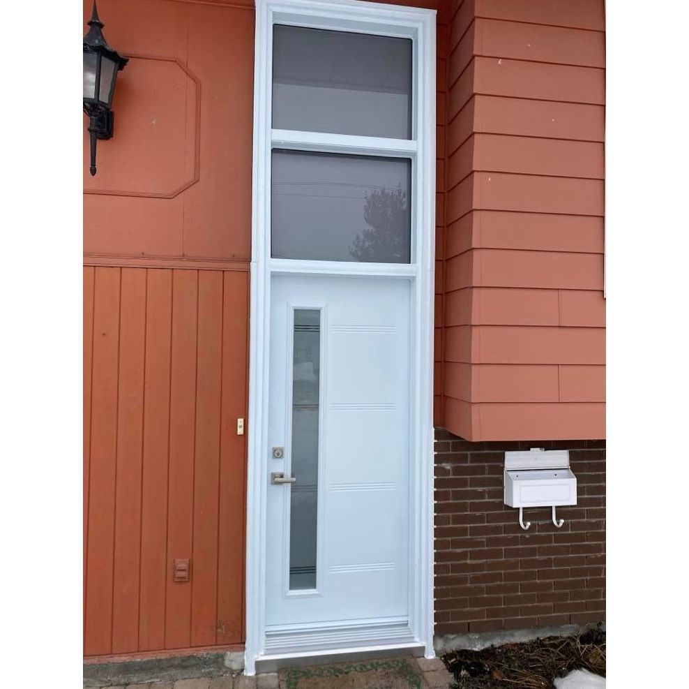 A white door with a window and a mailbox on the side of a house.