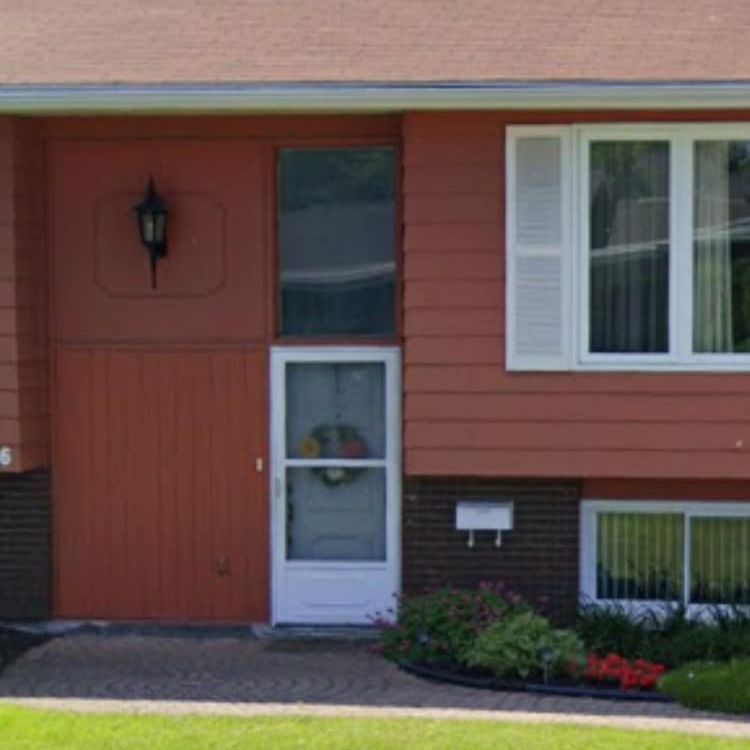 A red house with a white door and windows