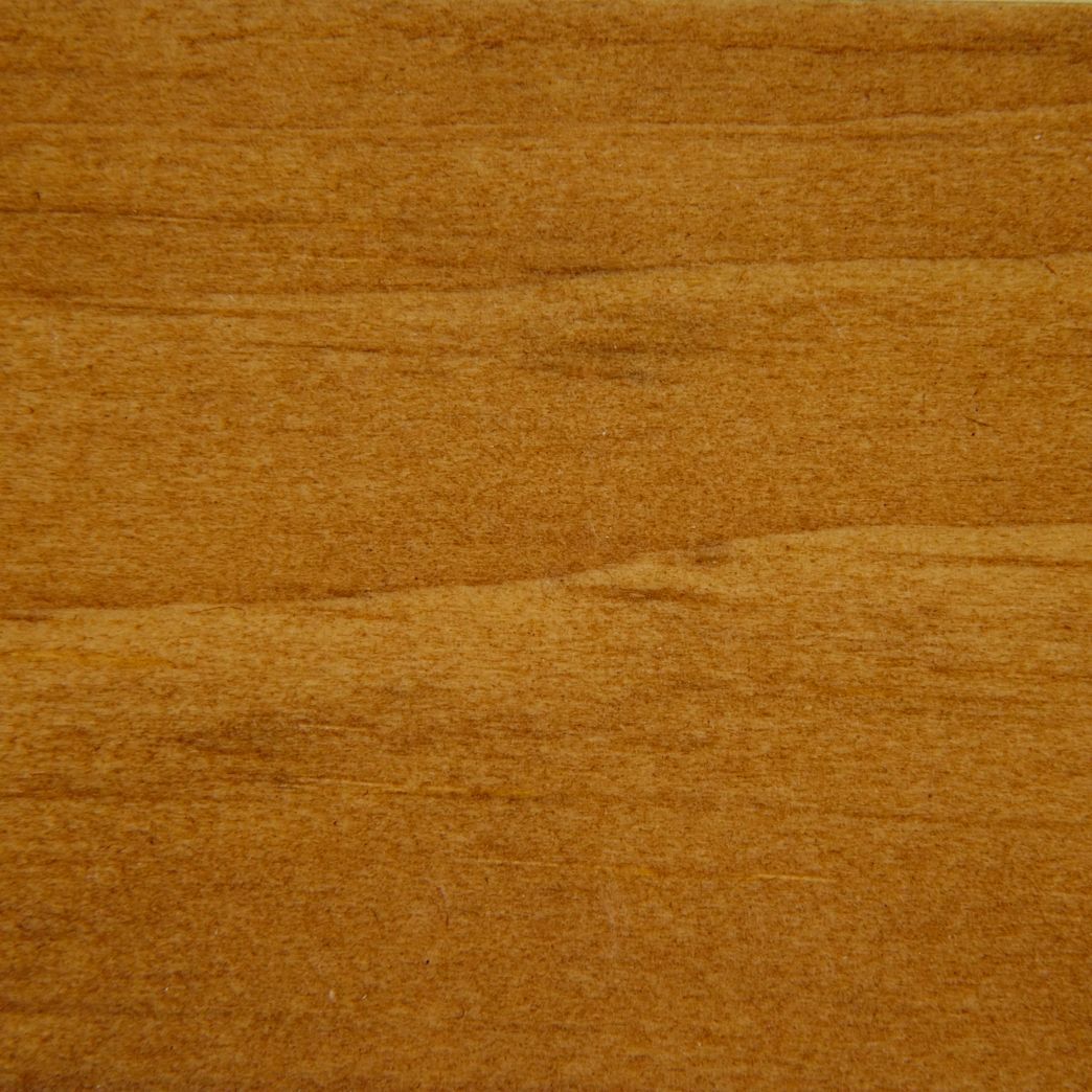 A close up of a piece of wood showing the grain and texture.
