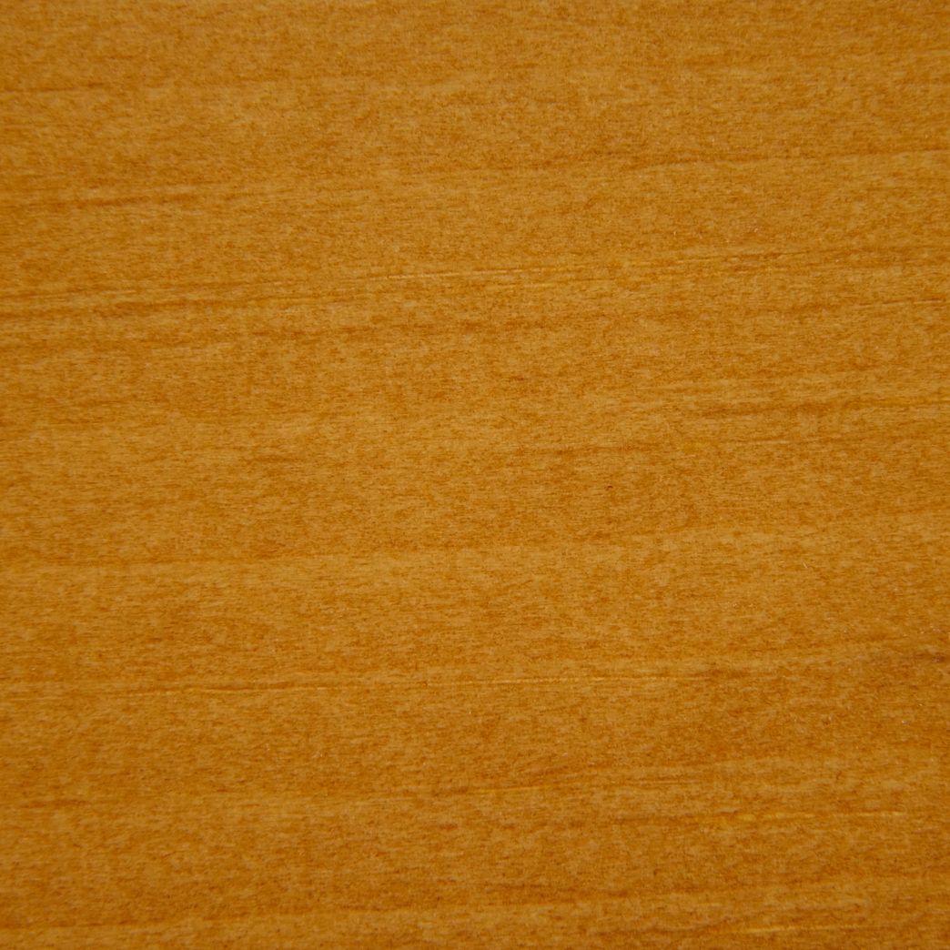 A close up of a piece of wood showing the texture of the wood.