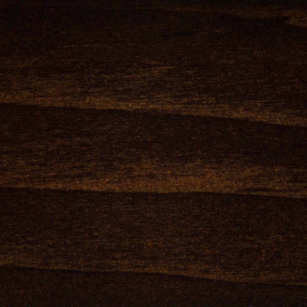 A close up of a piece of dark brown wood.