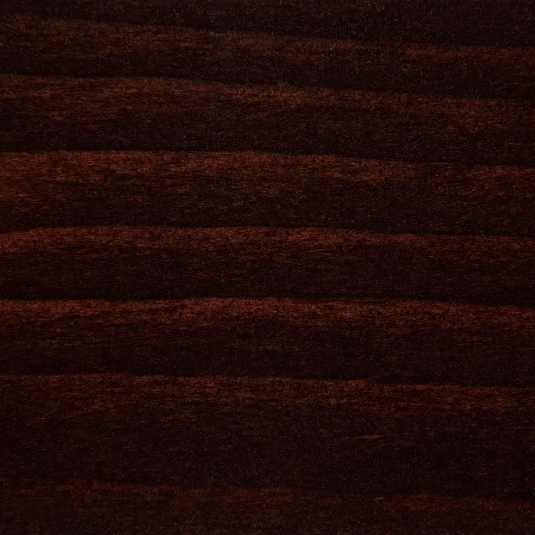 A close up of a piece of wood with a striped pattern.