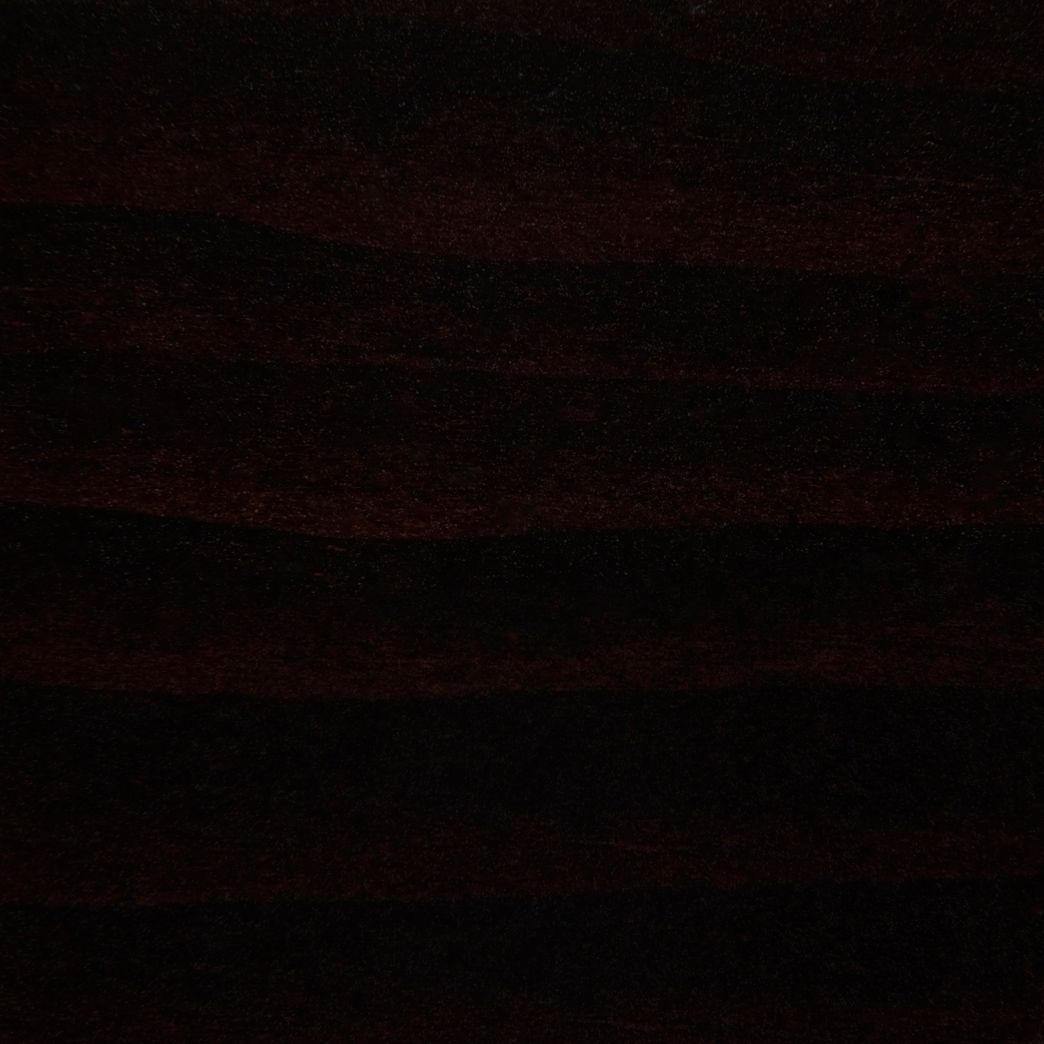 A close up of a dark brown wood grain texture.