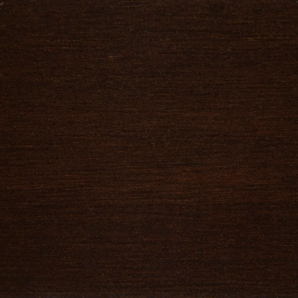 A close up of a piece of dark brown wood.