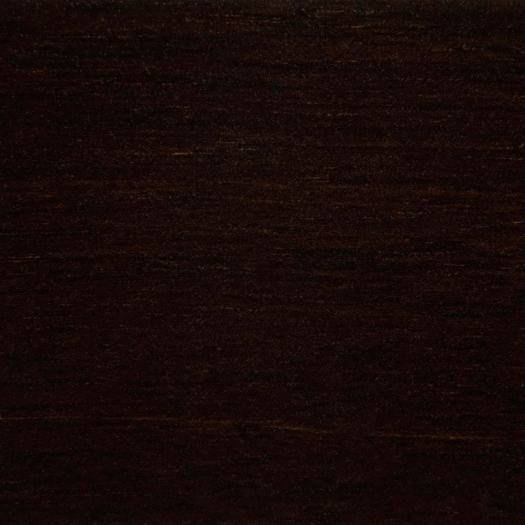 A close up of a piece of dark wood.