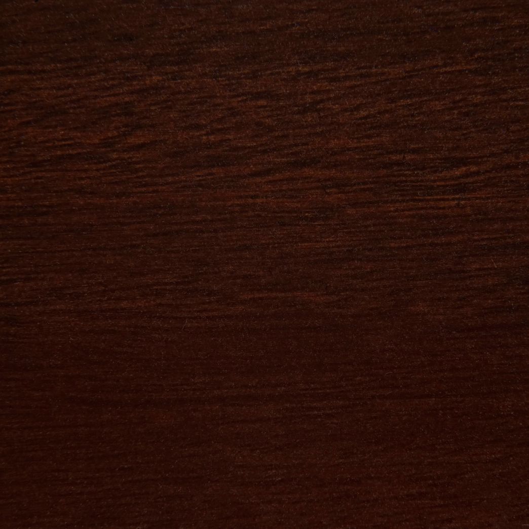 A close up of a piece of dark wood.