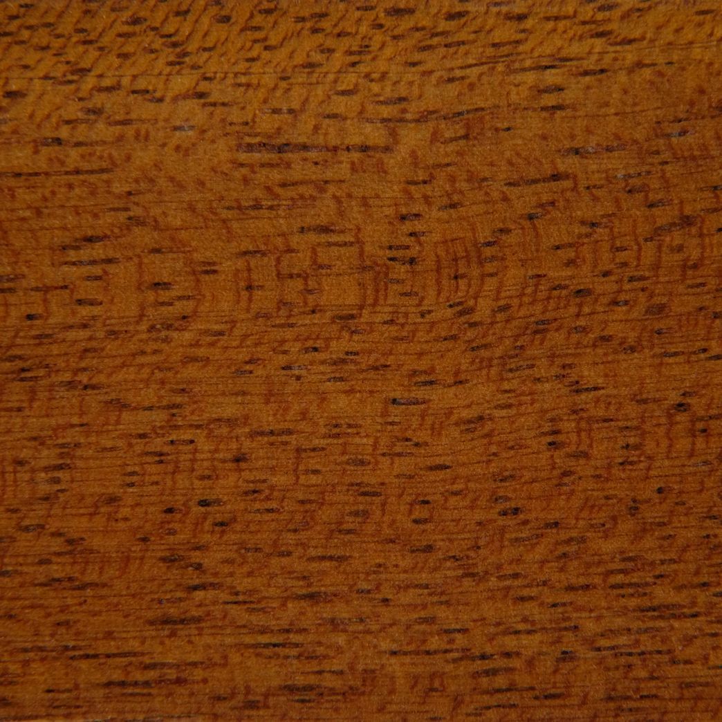 A close up of a piece of wood showing the texture of the wood.
