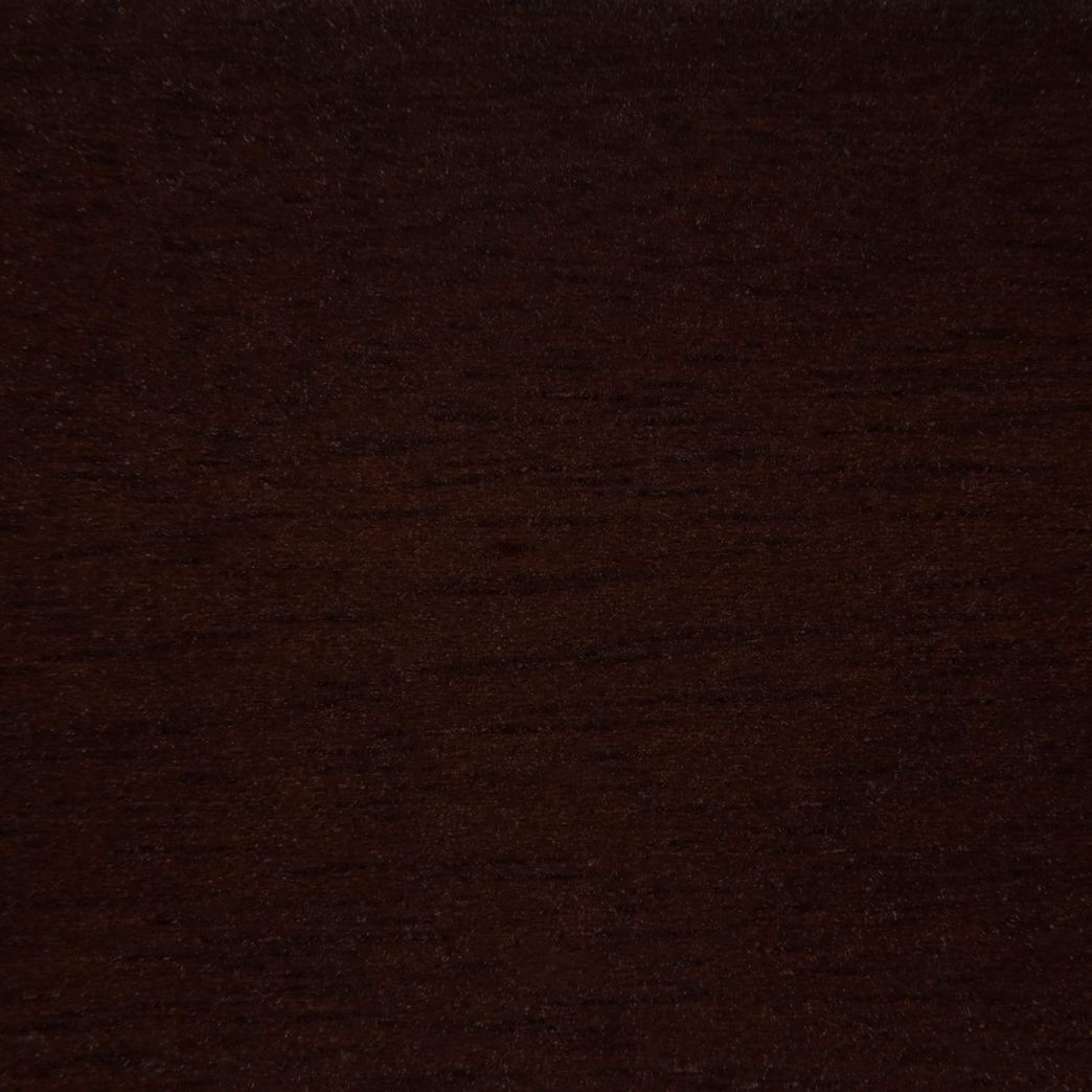 A close up of a dark brown wood grain texture.