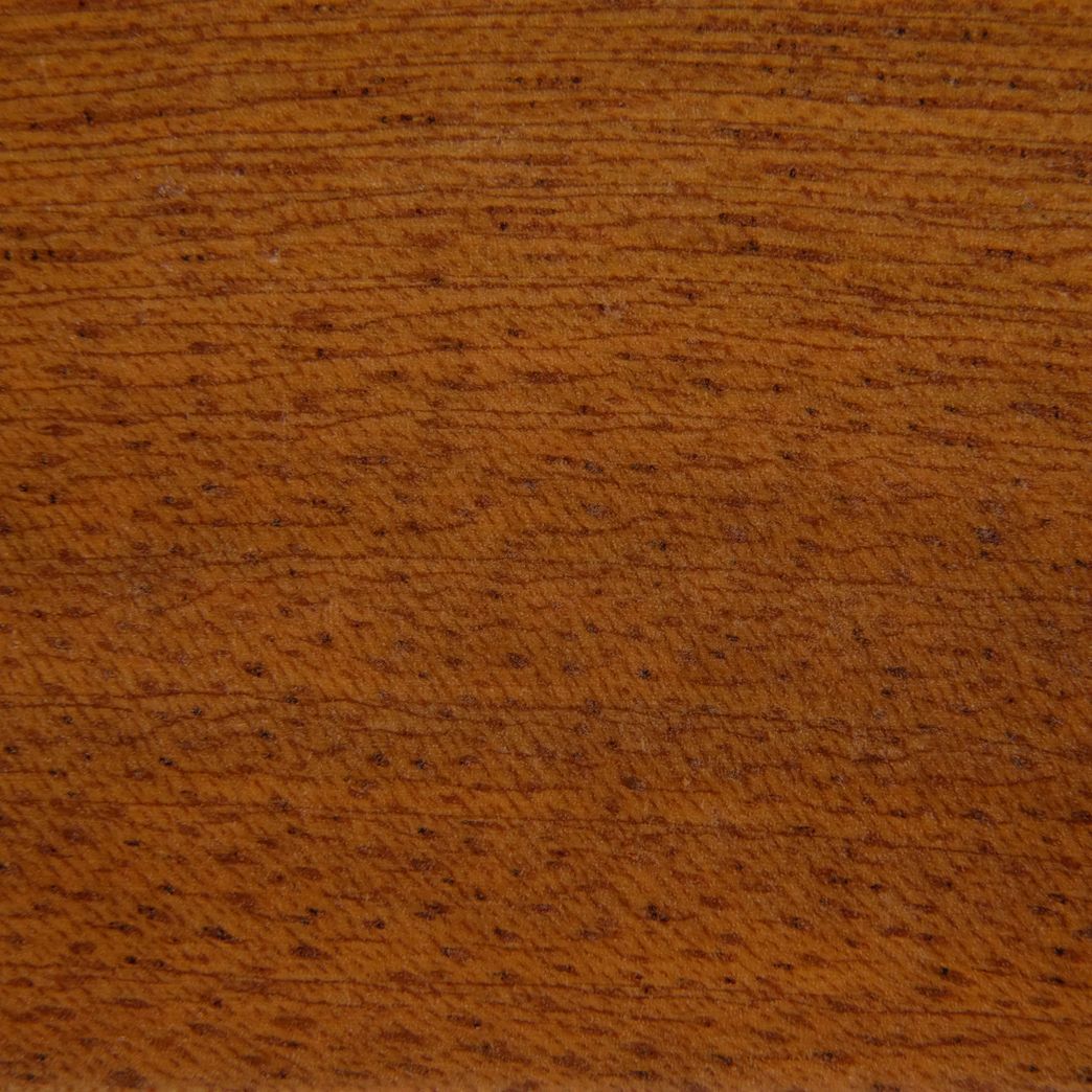 A close up of a piece of wood showing the grain and texture.