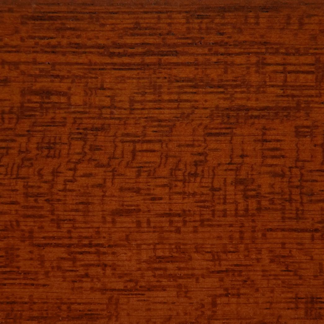 A close up of a piece of wood with a grain pattern.