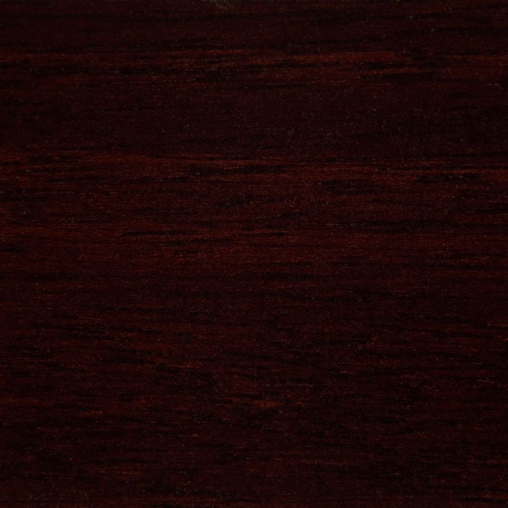 A close up of a dark brown wood grain texture.