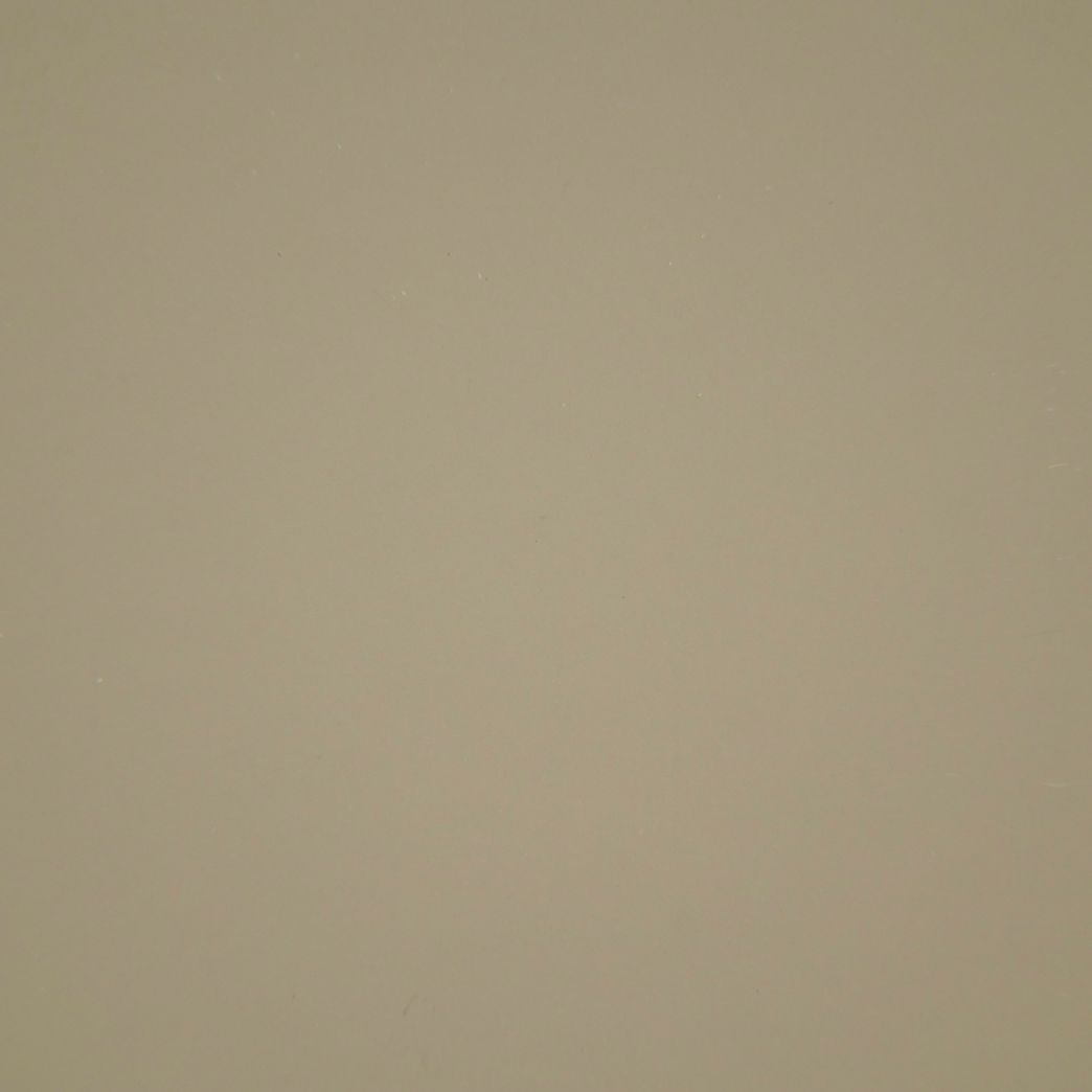 A close up of a beige paper texture.