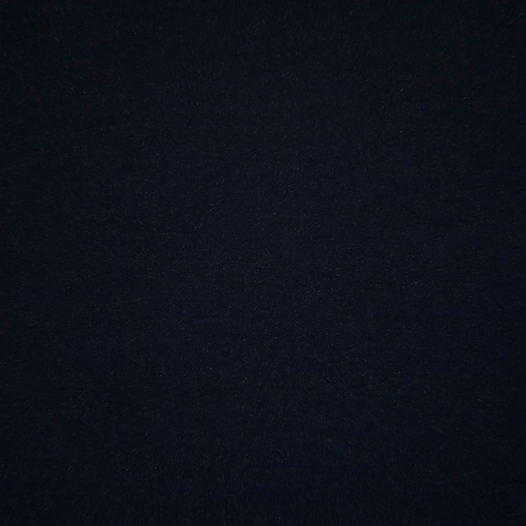 A close up of a black background with a grainy texture.