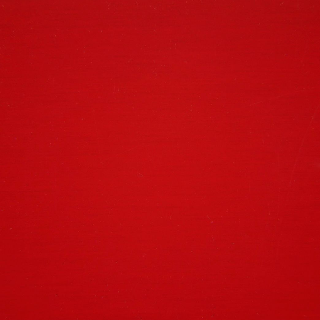 A close up of a red background with a plain texture.