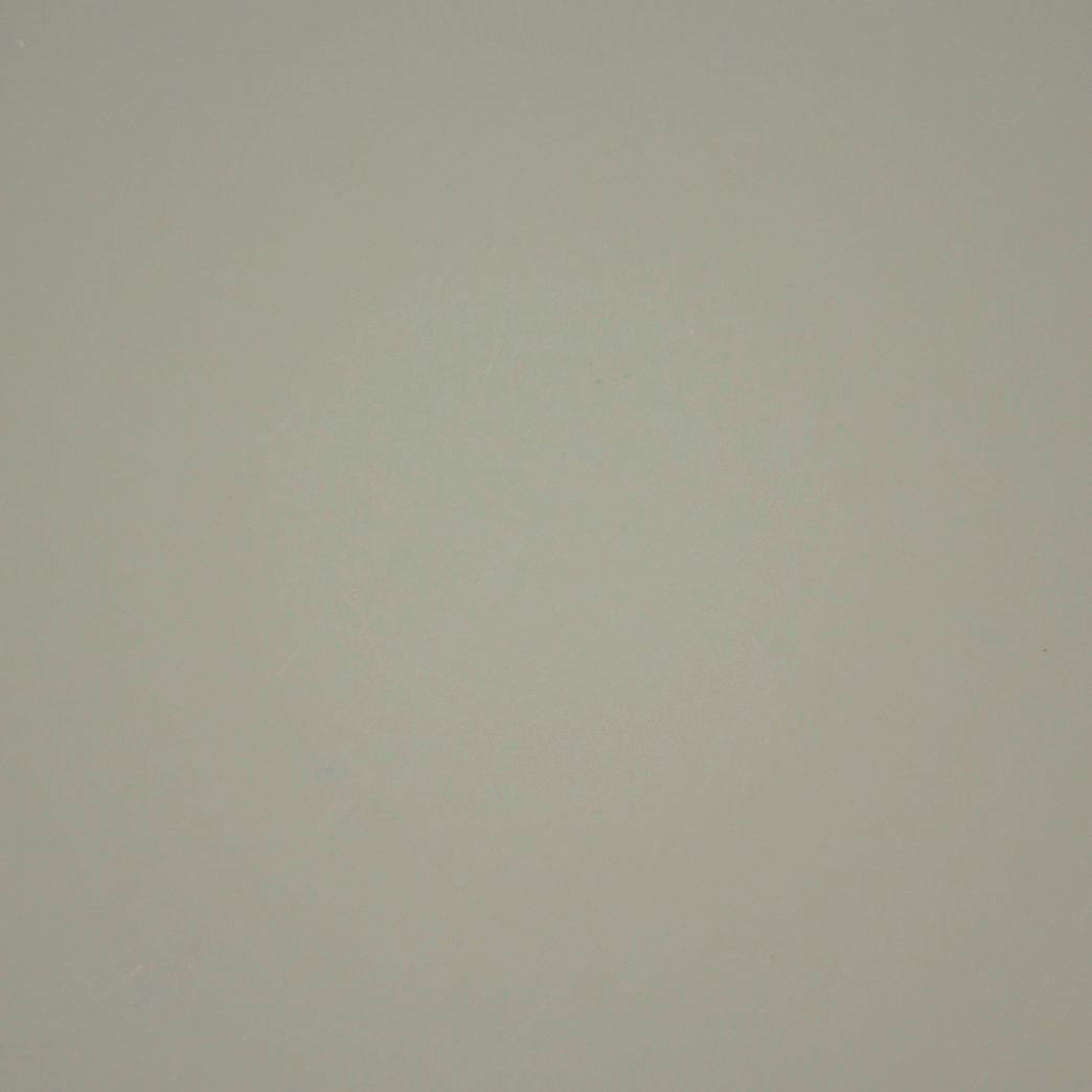 A close up of a white background with a plain texture.