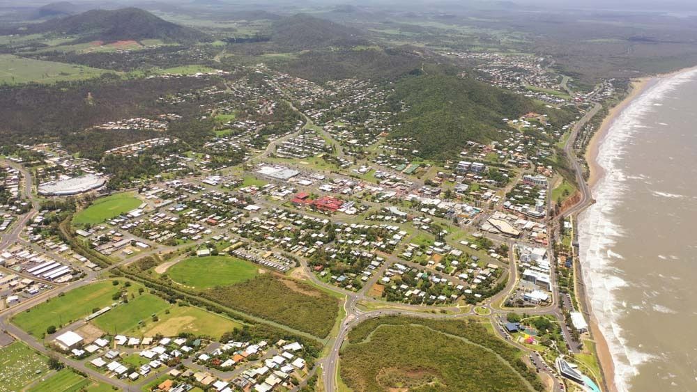 Aerial View of a Coastal Town With Buildings, Roads, Beach, and Green Fields — SSP Insurance In Yeppoon, QLD