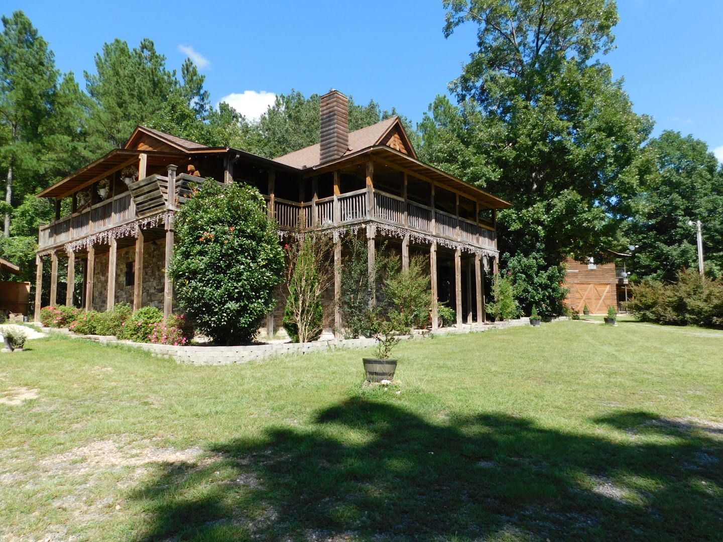 A large house with a lot of trees in the background