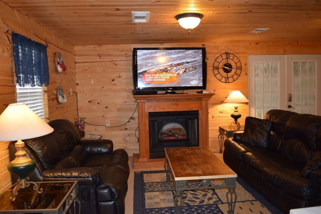 A living room with a fireplace and a flat screen tv