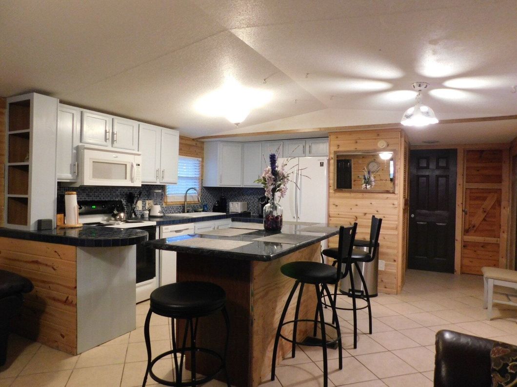 A kitchen with a large island and stools