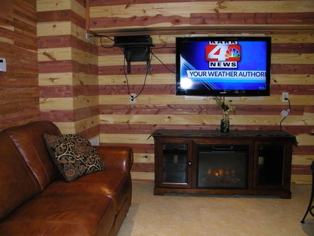 A living room with a fireplace and a tv that says 4 news