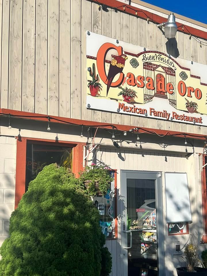 Casa de Oro Mexican Family Restaurant exterior with sign and open door.