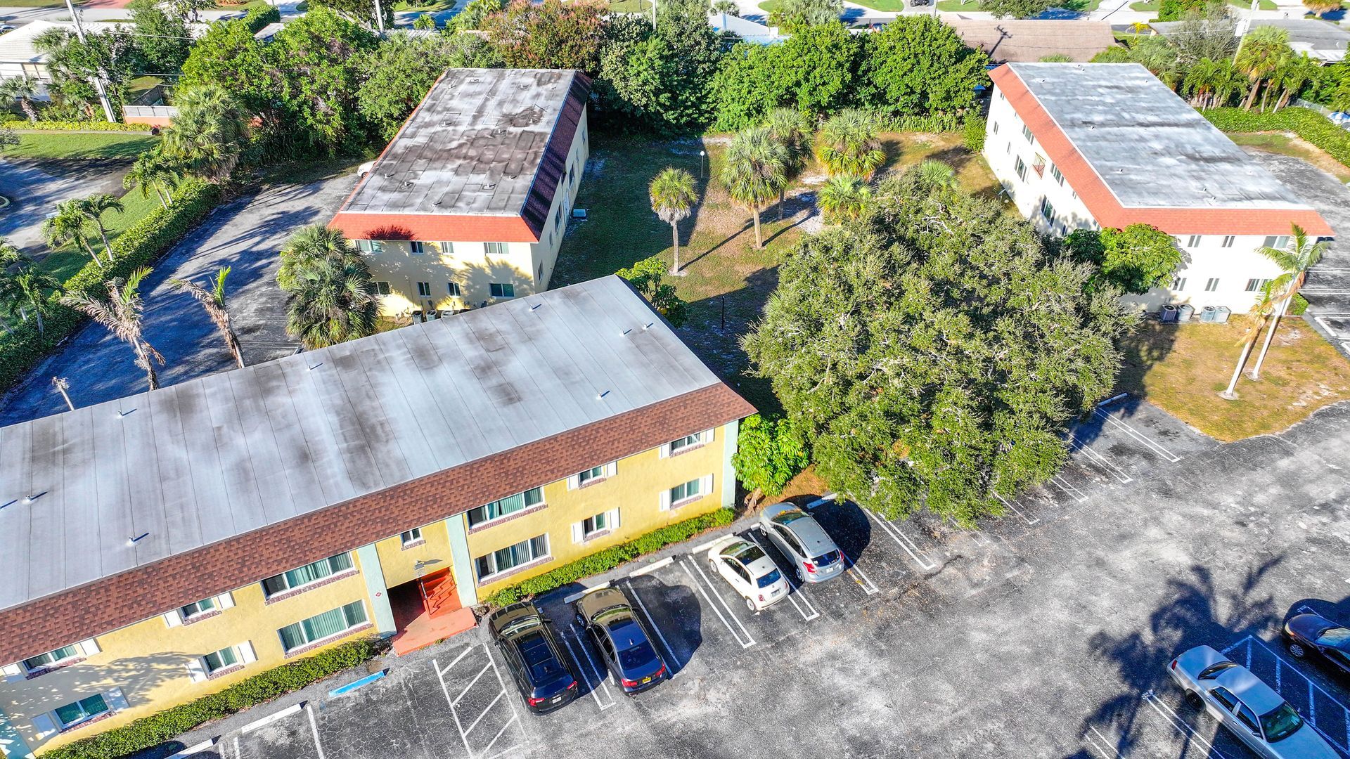 Photo of the apartment complex seen from a bird's eye point of view - alternate angle, showing the parking lot