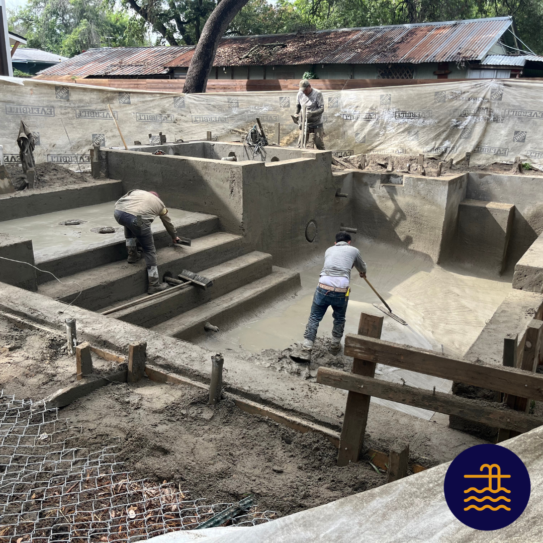 A group of men are working on a swimming pool