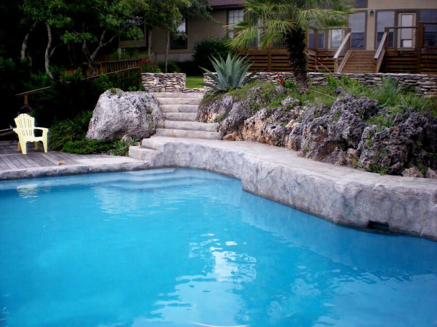 A large swimming pool with stairs leading up to it