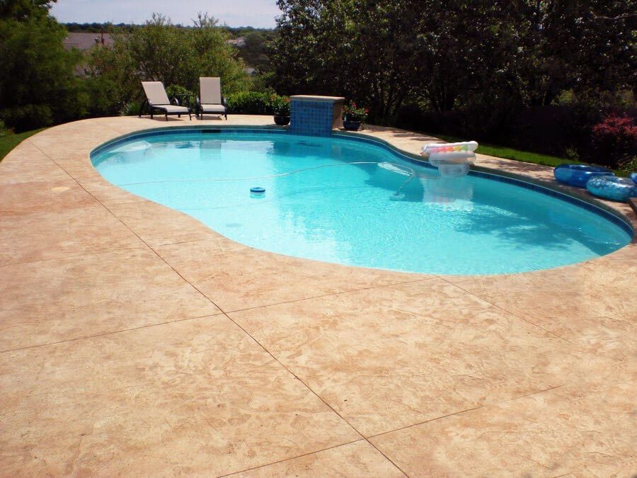 A large swimming pool with a waterfall in the middle