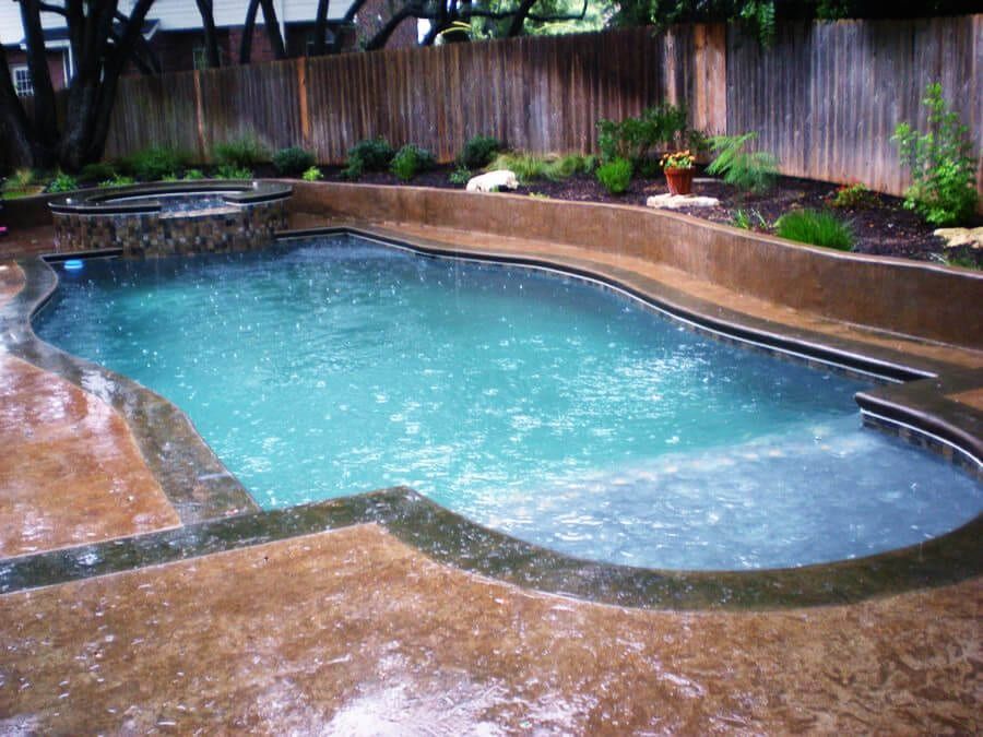 A large swimming pool with a fence in the background
