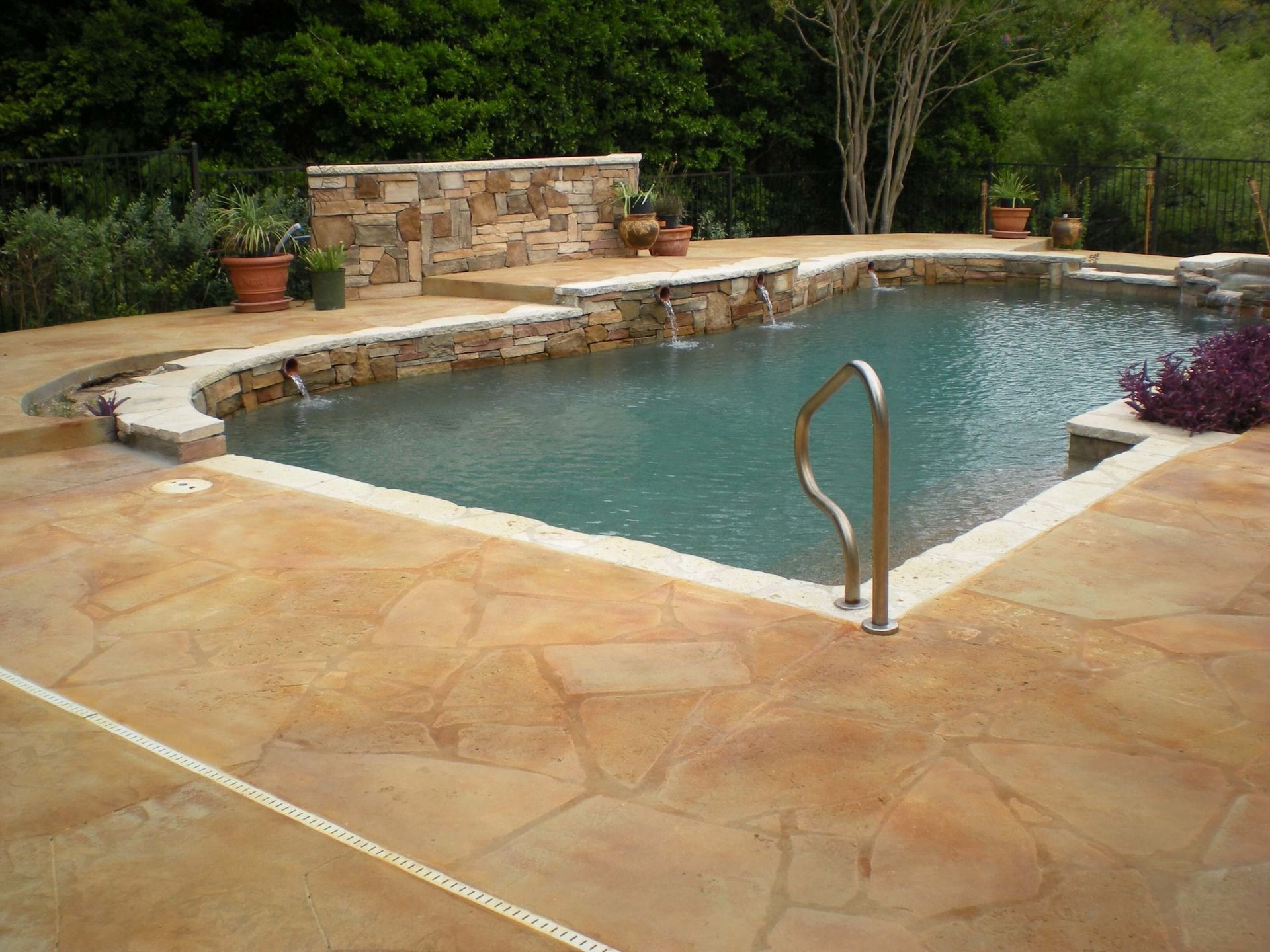 A large swimming pool with a staircase leading to it