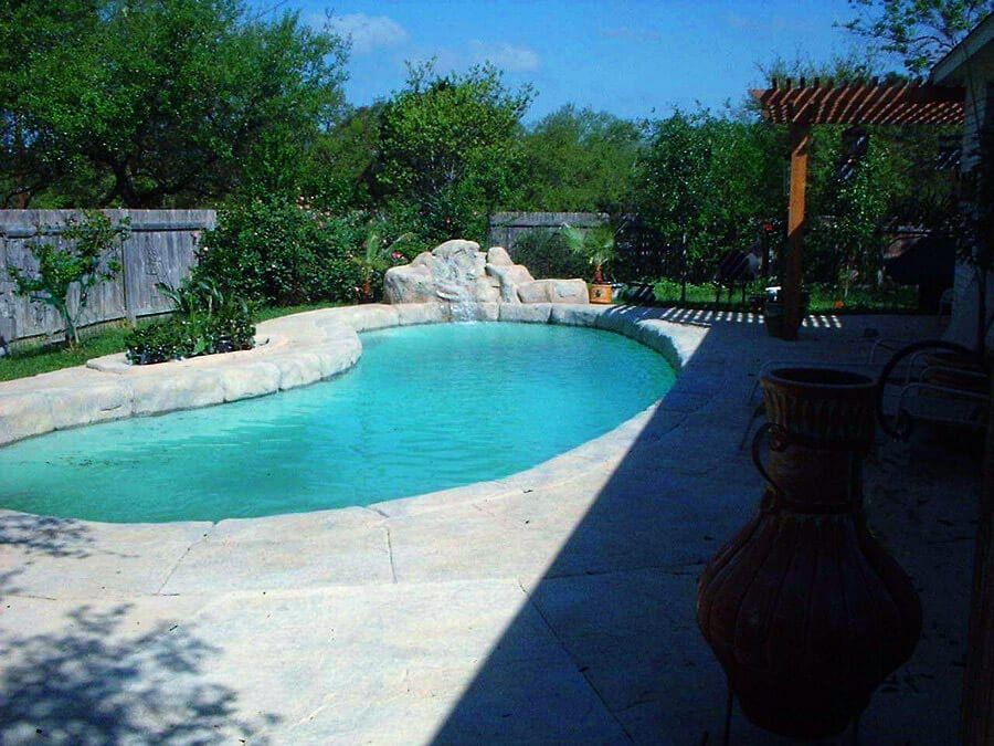 A large swimming pool in the backyard of a house