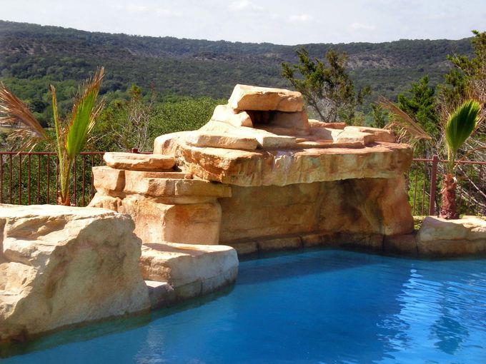 A swimming pool with a waterfall in the background