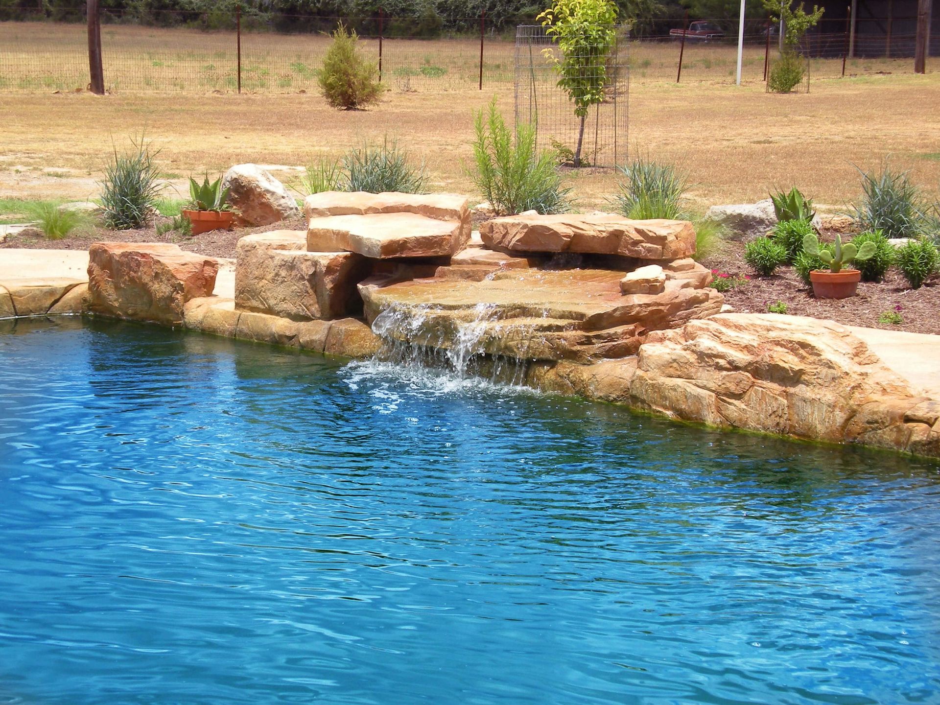 A pond with a waterfall in the middle of it
