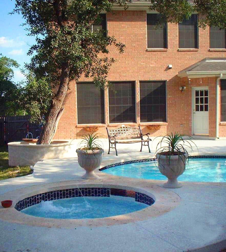 A large brick building with a swimming pool in front of it