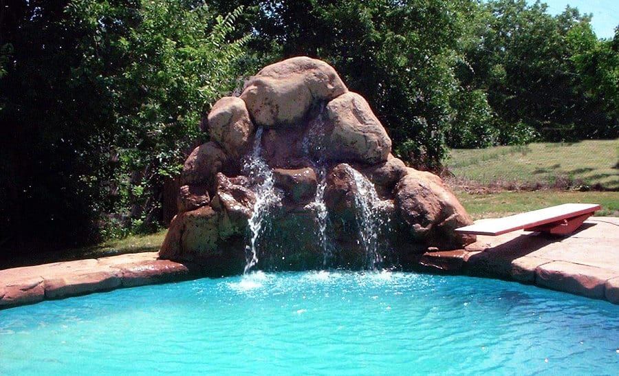 A pool with a waterfall in the middle of it