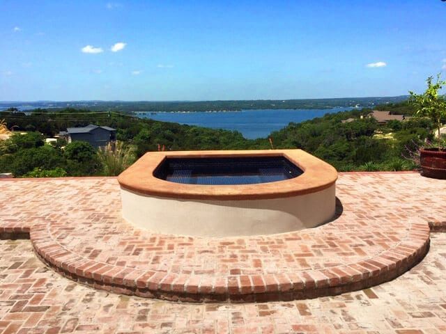 A hot tub with a view of a lake