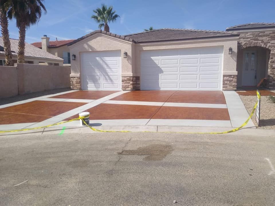 A house with two garage doors and a concrete driveway